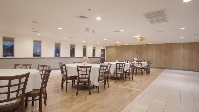 A bright hall set with round tables