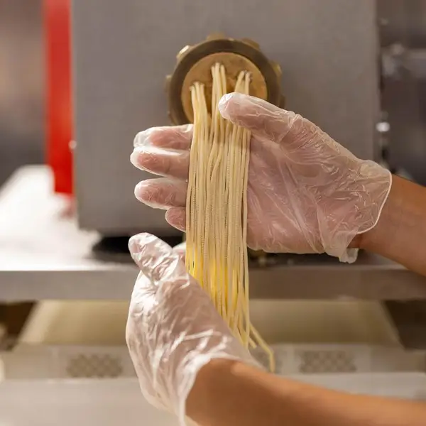 Fresh pasta coming off the pasta machine
